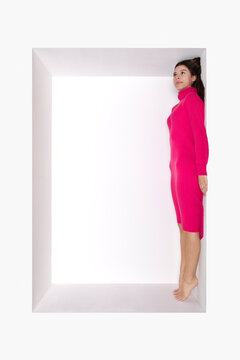 Teenage girl standing tiptoe in alcove