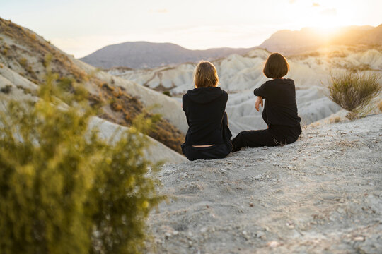 Friends enjoying nature in the desert at sunset