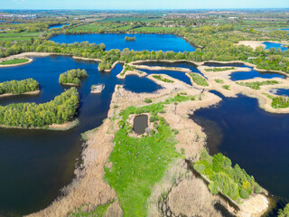 Wonderful drone photography view of many lagoons and small lakes seen in the Fen Drayton reserve in Cambridgeshire, UK. In the far distance is the market town of St Ives. © Nick Beer