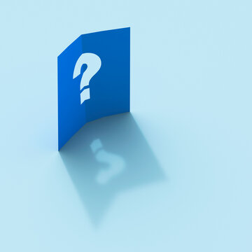 Blue folded paper with question mark cut out casting a shadow
