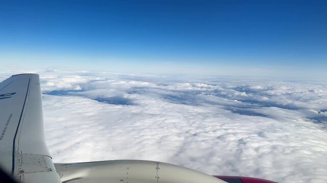 Journey Through Skies. Flying High Above Endless Clouds. Peering Through Window At Airborne Adventure Happening Outside. Experience Thrill Of Sky Travel With Detailed Aircraft View And Vast Clouds