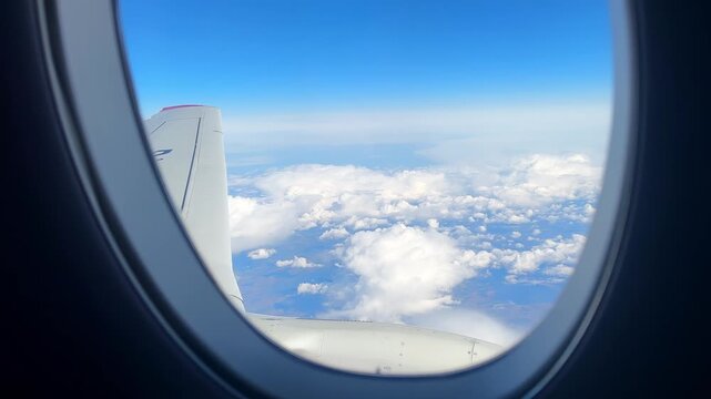 Scenic Aerial Landscape Seen From Airplane Window With Winglet, Scattered Clouds Over Land, Approaching Descent Feel, Warm Daylight, Expansive Horizon, Passenger Viewpoint