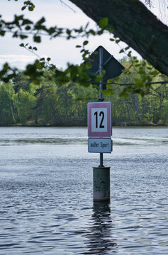 A Traffic Sign Indicating Speed Limit 12 Except For Sports On The Water