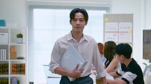 Young Asian colleagues teamwork in modern office space Discussing market trends and conducting data analysis to develop a successful business strategy together