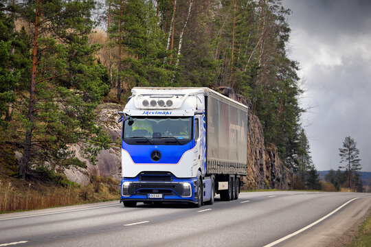 New blue white Mercedes-Benz Actros L 1845 ProCabin truck transports load along highway. 