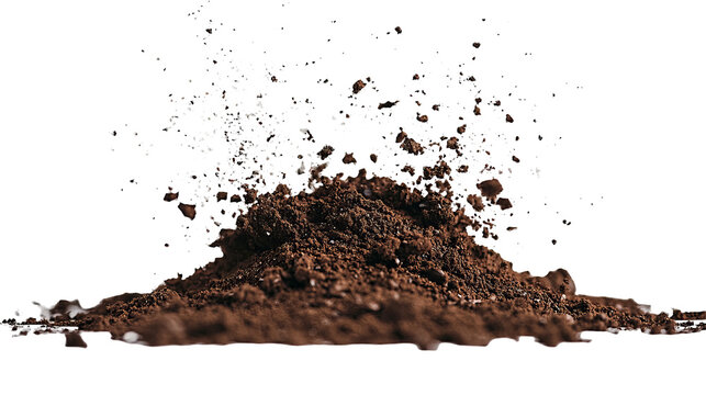 Pile of brown earth exploding with specks against a black background