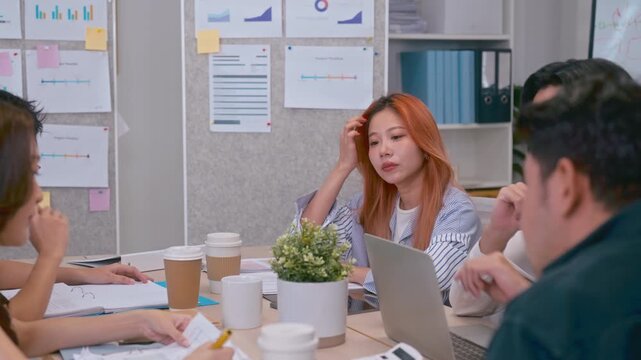 Young Asian colleagues teamwork in modern office space Discussing market trends and conducting data analysis to develop a successful business strategy together