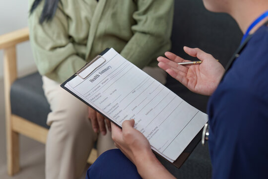 Asian healthcare professional discussing health summary with patient