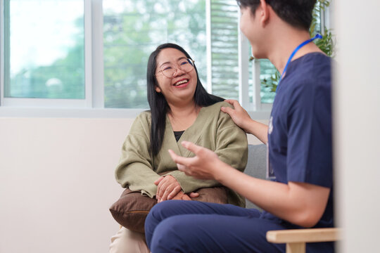 Asian healthcare professional providing support to happy woman patient
