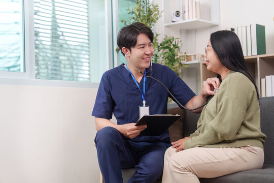 Asian healthcare professional performing medical checkup on woman patient