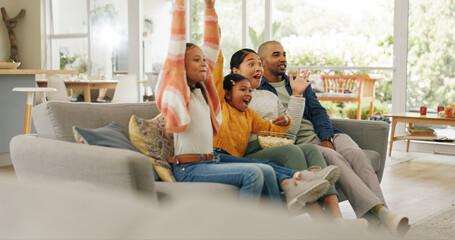 Parents, children and watching tv in home with celebration, sports game or bonding together on...