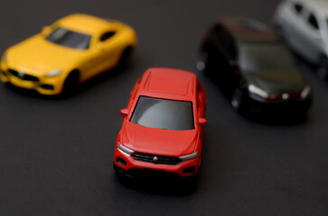 Fototapeta premium Front View of Red Crossover Model Car on Dark Surface