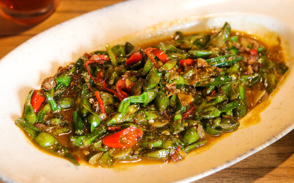 A plate of a traditional Indonesian vegetable dish made from stir-fried yellow velvetleaf (Tumis Genjer).