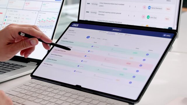 Young Hispanic Man Carefully Tracking OKR Progress
