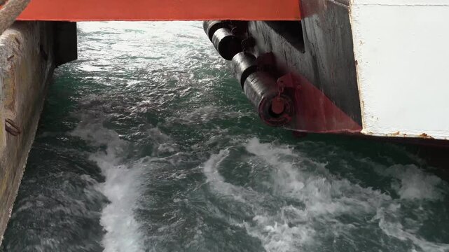 Ship's propeller water swirling from back side 