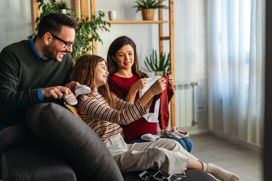 Pregnant woman with loving family preparing for baby birth. Happy mother enjoying pregnancy.
