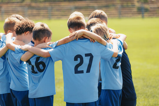 Happy Children United in Sports Team. Kids Building Team Spirit Altogether With a Coach. Boys in Blue Uniforms Play Sports Game Outdoor