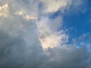 Fototapeta premium Dramatic storm clouds filling sky with heavy gray tones and soft light breaking through horizon