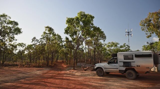 Off road vehicle parked at Old Telegraph Track sign near Bramwell Junction, Cape York, Queensland, Australia. Iconic 4WD route, remote adventure travel in rugged outback terrain.
