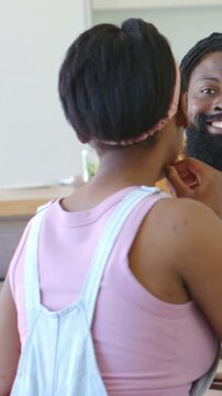 Daughter pointing, clarifying in kitchen, father smiling, animated lines showing gesture, education