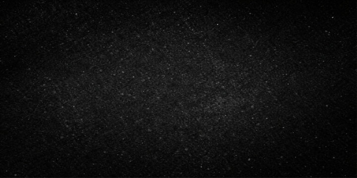 A textured black and white pattern of snow falling down against a dark night sky creates a rough macro background with the appearance of film grain or stars in space