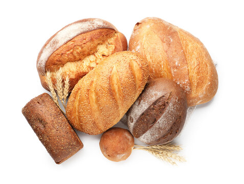 Different types of bread and spikes isolated on white, top view