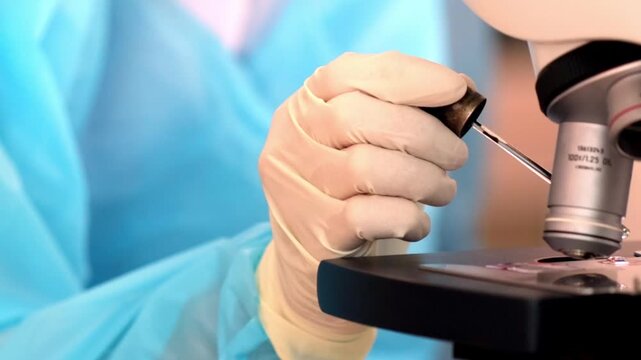 A glove laboratory microscope medical science research sterile close up equipment analysis healthcare clinic sample test experiment technician examination biology chemistry plastic protective lab