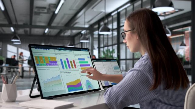 Woman Analyzing Business Data On Computer Using Dashboard