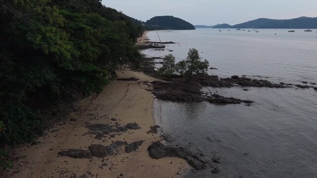 Aerial view of a tropical coastline with a shipwrecked boat