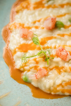 Gourmet presentation of a traditional Italian seafood risotto served on an elegant restaurant plate. The image captures the rich, creamy texture of the perfectly cooked rice beautifully combined with 
