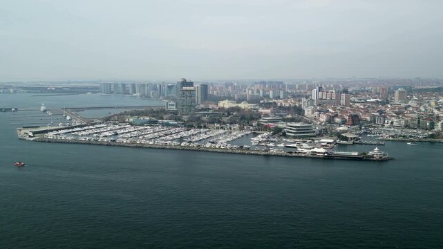 Atakoy Marina and Bakirkoy ferry with Istanbul city in the background zoom-in