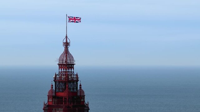 Aerial drone view footage of top of the Blackpool Tower in Blackpool Lancashire England during April showing the famous seaside landmark