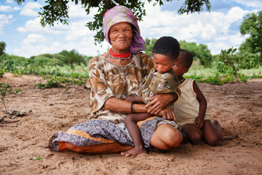 portrait of an Elderly San Woman with Two Young Children in Rural Botswana
