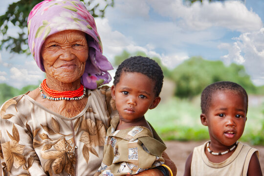 portrait of an Elderly San Woman with Two Young Children in Rural Botswana