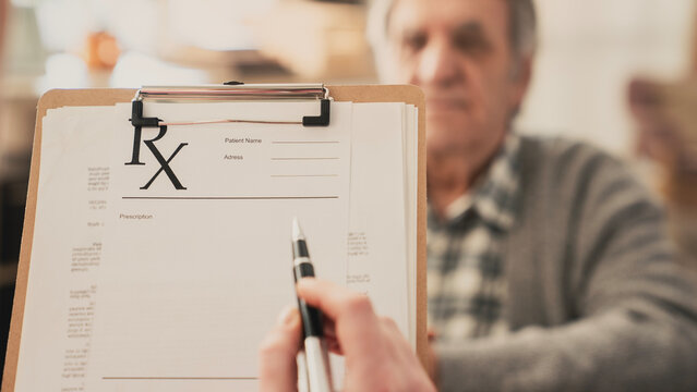 Doctor giving medical prescription to patient	