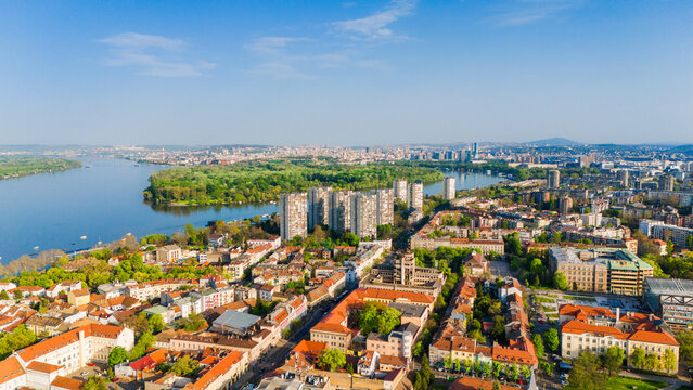 Aerial view of the historic Zemun district featuring red rooftops and modern residential towers along the Danube river with Great War Island in Belgrade, City of Belgrade, Serbia.