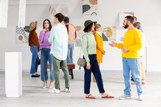 Group of people at exhibition in art gallery