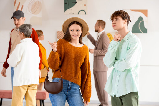 Young people at exhibition in art gallery
