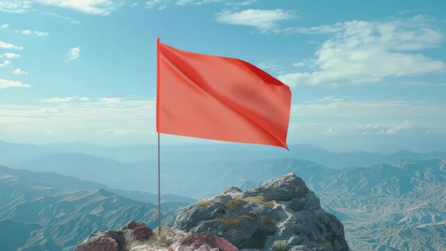 A vibrant red flag standing tall atop a rocky mountain peak, against the backdrop of clear skies and distant mountains.