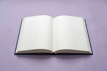 Fototapeta premium Open Blank Book on Purple Surface