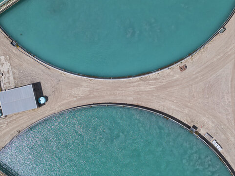 Aerial view of brilliant turquoise water in circular basins starkly contrasting the parched, earthy terrain, Tucson, Arizona, United States.
