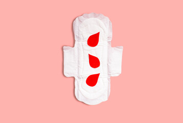 Menstrual pad with red drops on pink background. Menstruation cycle period, woman hygiene and comfort concept © Krievietka
