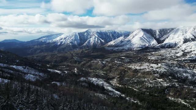 The California San Gorgonio San Bernardino Mountain Range near theSanta Ana River in the Watershed looking at the Mountains and trees covered in Snow after a Winter Storm from a UAV Drone Aerial Shot 