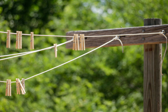 Wooden clothespins clipped to outdoor clothesline