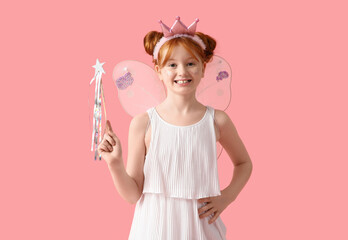 Naklejka premium Cute girl in fairy costume with magic wand on pink background