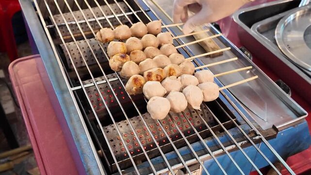 Grilled Fish Ball Skewers on Charcoal Grill Phuket Thailand 4K