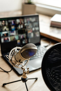Home studio for podcast recording. Interior with microphone and laptop on table