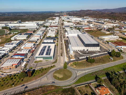 Aerial view of the industrial park's geometric precision, with rows of warehouses and factories intersected by roads, Albergaria-a-Velha, Aveiro District, Portugal.