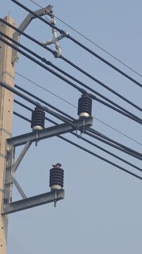Detached distribution power line from insulator touching crossarm causing electrical fault hazard.