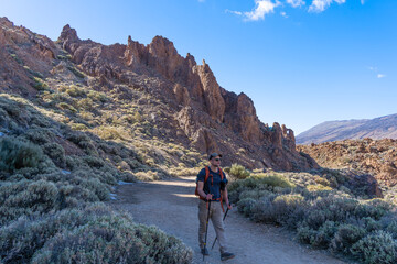 Fototapeta premium The hiker is walking along the Pista de Sieste Canadas trail in Teide National Park